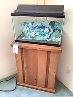aquarium on wood stand with hood in corner view