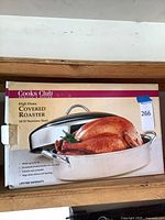 Front of boxed Cooks Club high dome covered roaster showing product image and box details