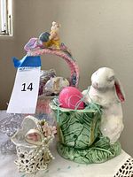 Group shot showing ceramic bunny planter, crocheted basket with eggs, glass bird dish, and lace favor cup
