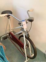 Full side view of exercise bike showing frame, chain guard, front wheel