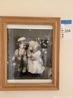 Overall view of framed print showing image of children and wood frame