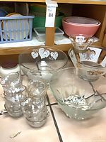 Group view of punch bowl set, ornate bowls, faceted bowl, mixing bowl, plastic containers