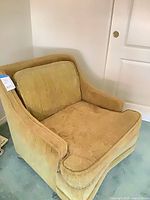 Full view of mustard gold armchair showing style and condition