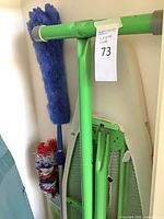 Folded ironing board with two static dusters alongside