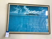 Front view of framed seascape print hanging on wall