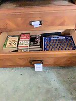 Drawer containing books and States of the Union coin board
