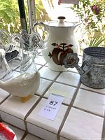 overall lot showing ceramic pitcher, goose figurine, glass angels and tag