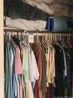Rack of assorted ladies tops and sweaters on hangers