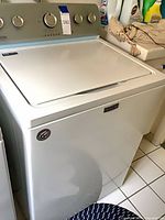 Front and top view of Maytag white top-load washer showing full appliance