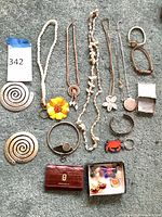 Full layout of all jewellery pieces, watch, earrings box and wallet on carpet