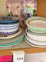 Overall lot showing stacked plates, bowls, square floral platter