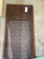 Both brown rectangular rugs stacked, showing color and pattern