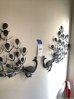Both metal peacock wall sculptures mounted on wall