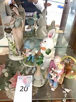 Group shot of all figurines on glass shelf