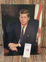 Front view of unframed JFK color print on upholstered surface