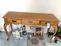 Front view of console table showing overall design and three drawers
