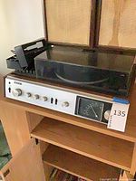 Front view of Sony HP-199 system showing silver control panel, tuning dial, wood cabinet and turntable