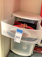 Drawer organizer with one drawer open showing belts