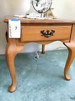 Three-quarter view of entire end table showing cabriole legs and drawer front
