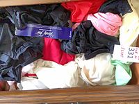 Drawer containing multiple colored Vanity Fair slips with size tag visible