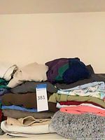 Stack of folded sweaters various colors