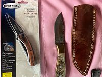 Packaged Sheffield Granite folding pocket knife beside fixed blade knife and leather sheath