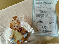 Ornament front with attached wings and certificate of authenticity