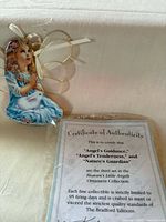 Angel ornament and certificate of authenticity in packaging