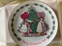 Front view of porcelain plate showing design, lettering, border and rim.