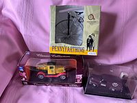 All three boxed items: Ford Model T truck, Chevrolet panel van, penny-farthing model