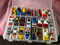 Open case, first side showing rows of Matchbox cars and trucks in individual compartments