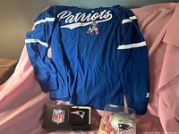 Full view of all three items: shirt, wallet, boxed mini helmet