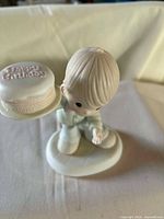 Full view of Precious Moments figurine child holding cake