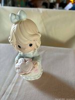 Front view of Precious Moments figurine showing girl with cookie