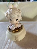 Front view of Precious Moments figurine in pot of gold