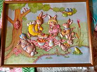 Front view of framed 3D rabbit picnic relief artwork