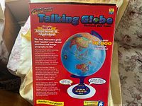 Front view of GeoSafari Talking Globe retail box showing product image and features