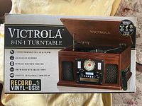 Front of retail box showing Victrola 8-in-1 turntable image and feature list