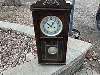 Full view of wall clock standing upright