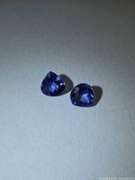 Both pear-cut tanzanites side by side showing shape and color