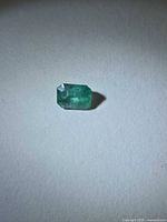 Top view of emerald showing octagon cut and color