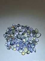 Group of small faceted tanzanite stones in mixed hues