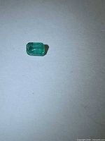 Octagon cut emerald on flat surface