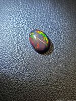 Top view of Ethiopian black opal displaying multicolor play