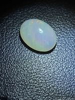 Top view of the oval opal showing body tone and play of color