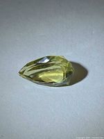 Loose pear-cut lemon citrine angled view showing facets and color