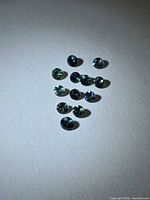 Group of 13 round faceted sapphires on neutral background
