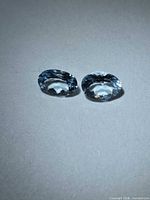 Pair of oval light blue aquamarines face up