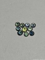 Group of 11 round faceted sapphires displayed crown up