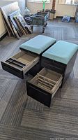 Both cabinets front view with drawers open showing file rails and teal cushions